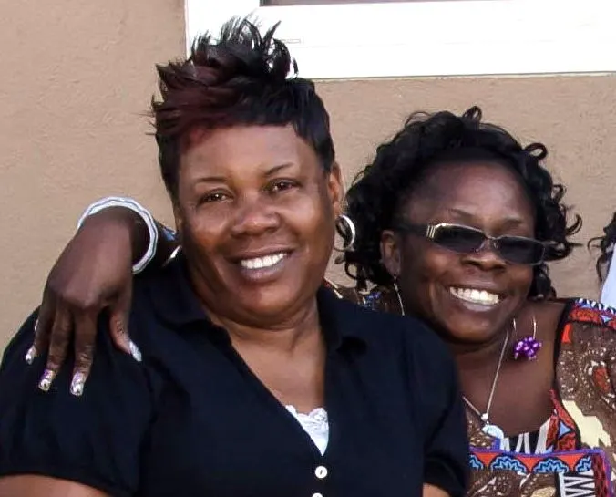 Two members embracing and smiling