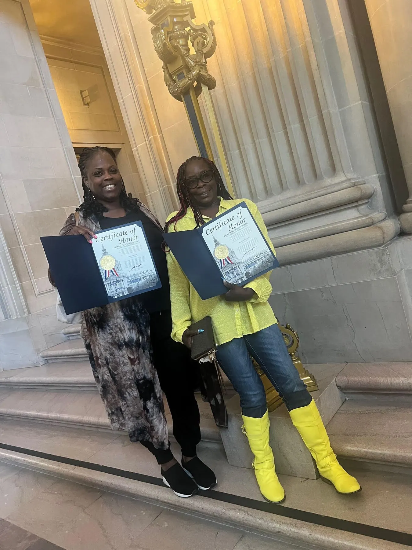 Two honorees at City Hall with their certificates