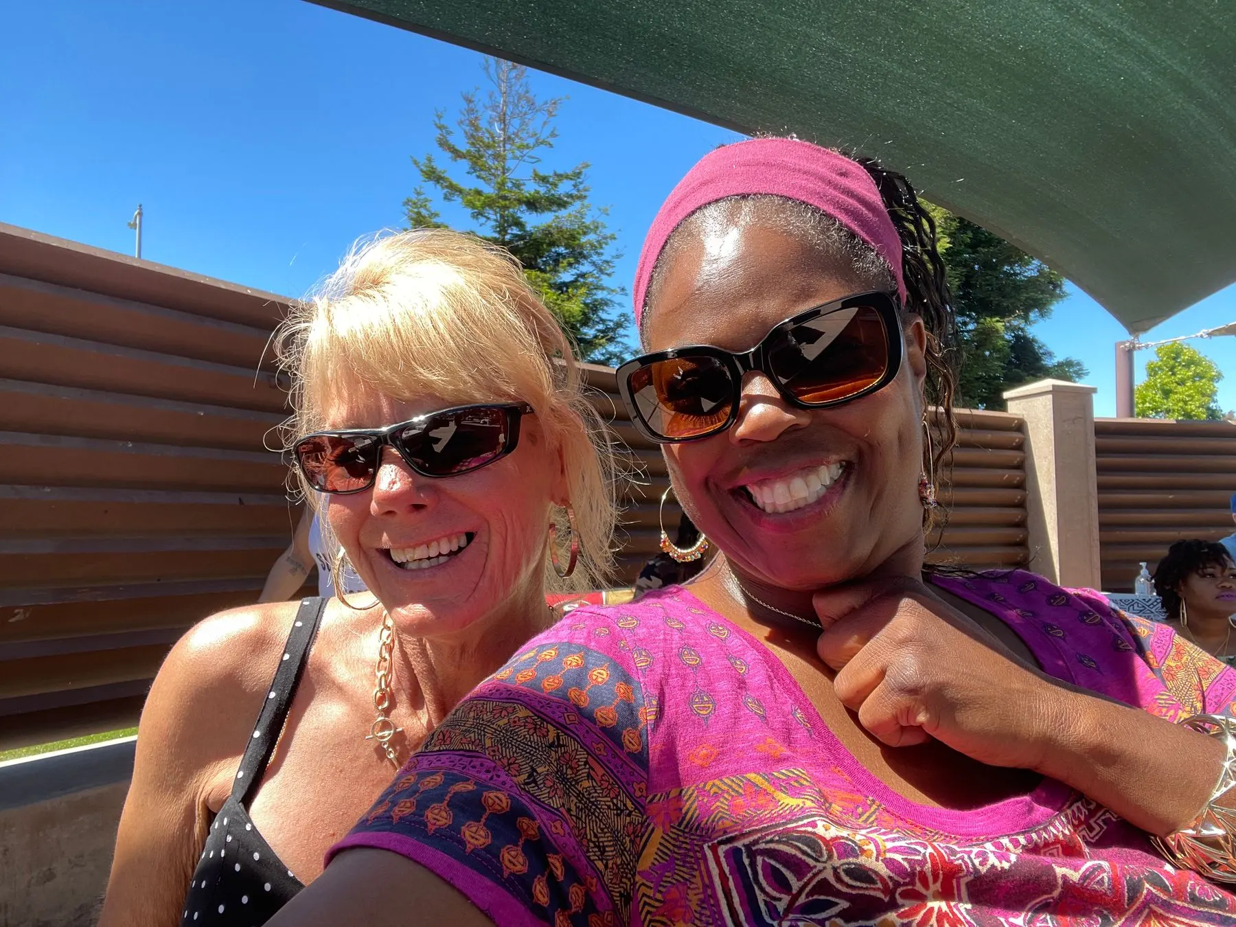 Two members smiling outdoors