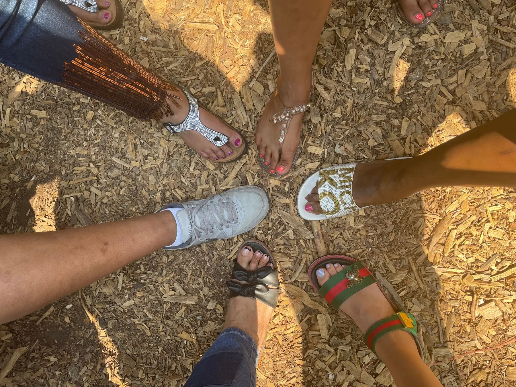 Members standing with their feet together in a circle