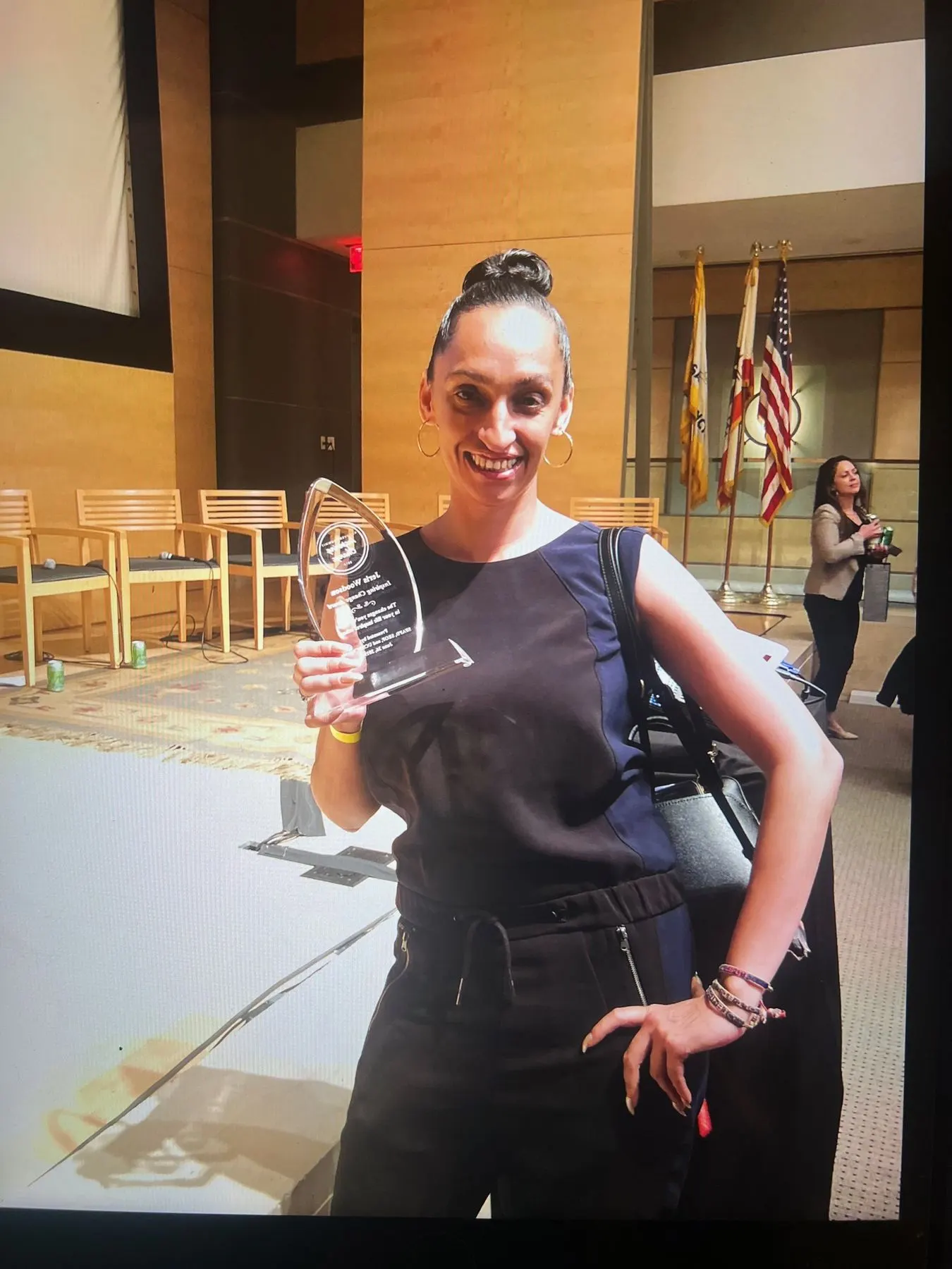 A member holding a glass award