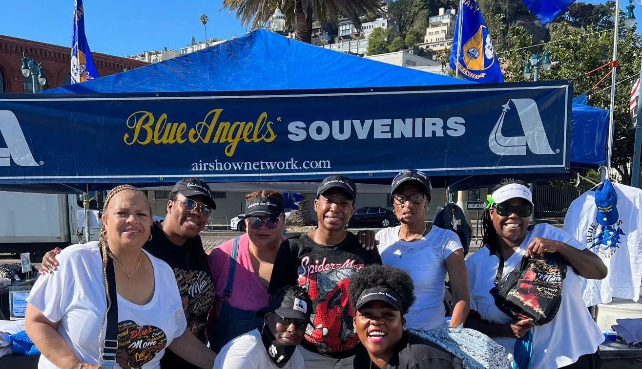 Volunteers at the Solutions for Women Fleet Week tent